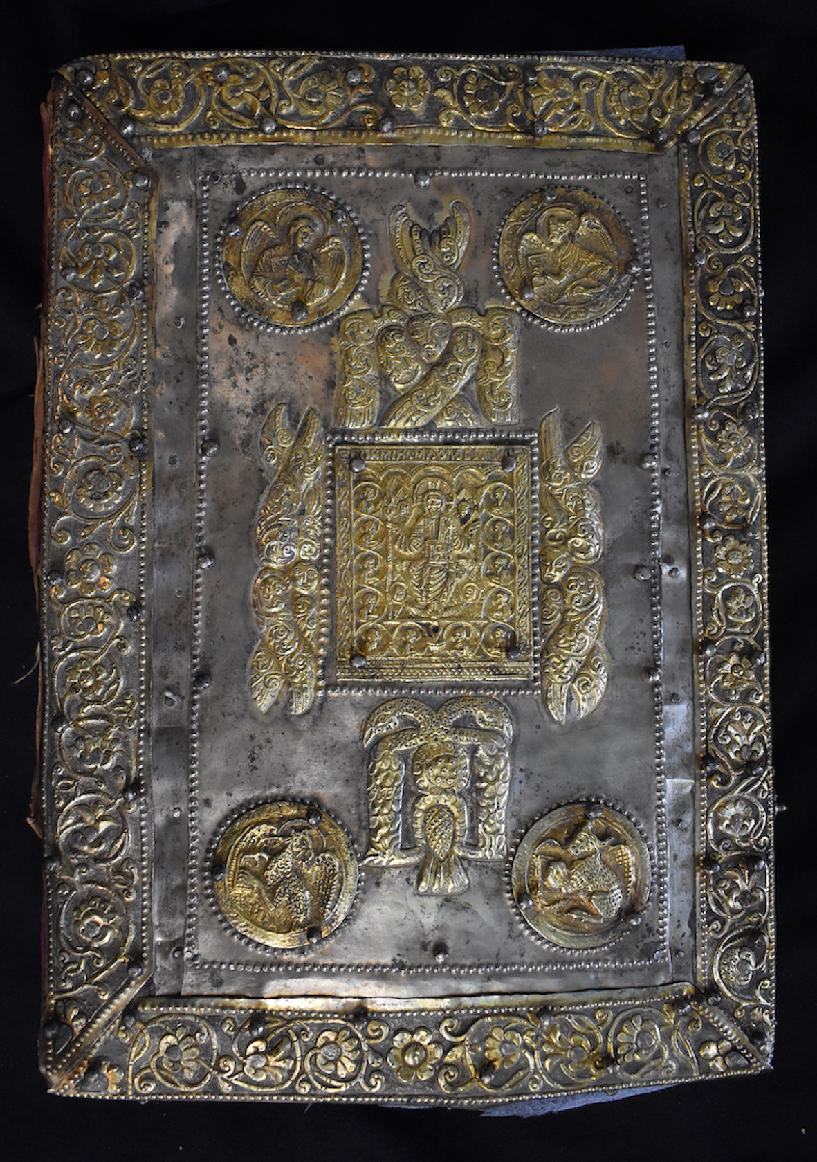 <p>Back cover of Gospel book by the goldsmith Dimos, 1673, front cover; wooden board, velvet, metallic plaques and stripes, partly gilt, enamel, repouss&eacute;, filigree, Church of St Nicholas, Metaxochori, Aghia, Thessaly) (source: project &laquo;Ecclesiastical Silver: Study and Documentation using Non-Destructive Techniques of Ecclesiastic Plate in Magnesia and Larissa Districts (15th - 19th centuries)&raquo; (MIS 5005968), Y. Varalis and C. Dolmas)</p>